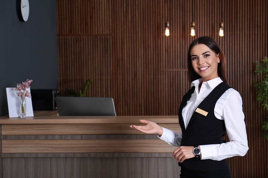 portrait of receptionist at desk in lobby